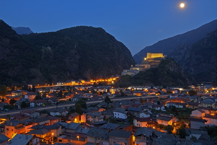 Fortress overlooking a town at night