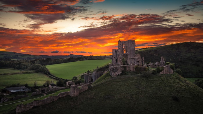 Corfe Castle ruins at sunset, Dorset, England