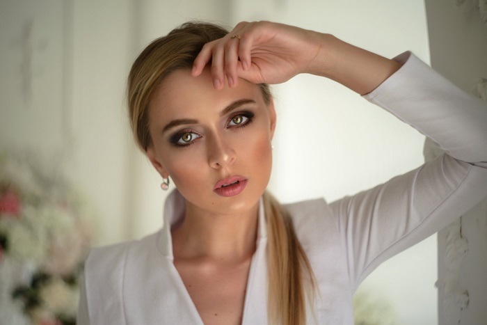 Blonde Woman with Hand on Forehead
