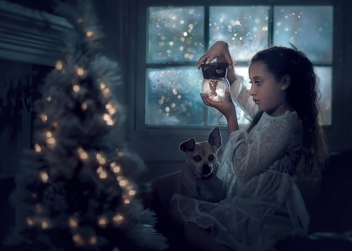 Girl holding a snow globe with a dog and Christmas tree
