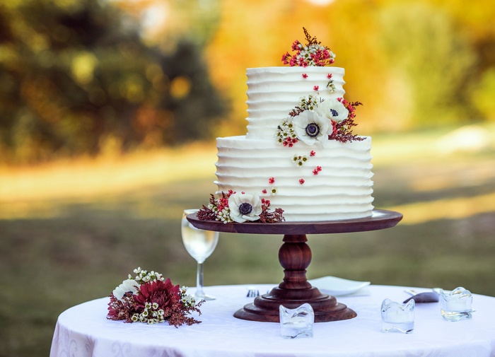 Two-tier white wedding cake with flowers