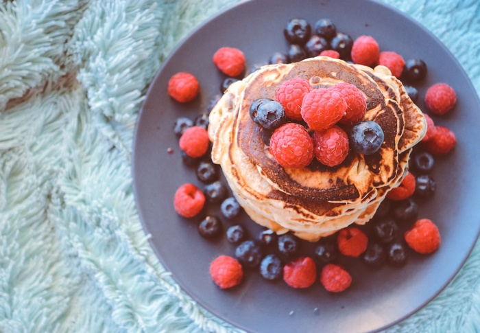 Stack of pancakes with raspberries and blueberries