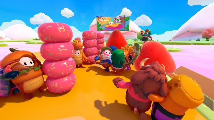 Fall Guys characters near donuts and strawberries