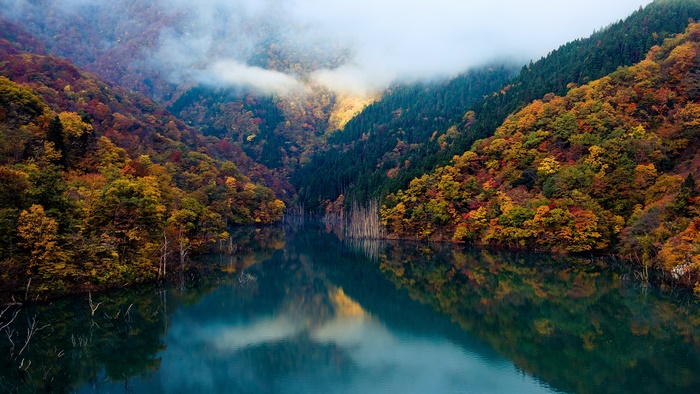 Mountain valley with lake and autumn forest