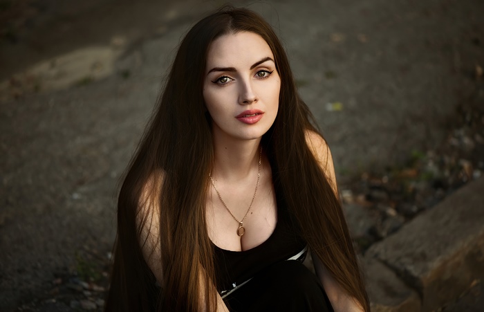 Brunette model with long hair wearing a necklace