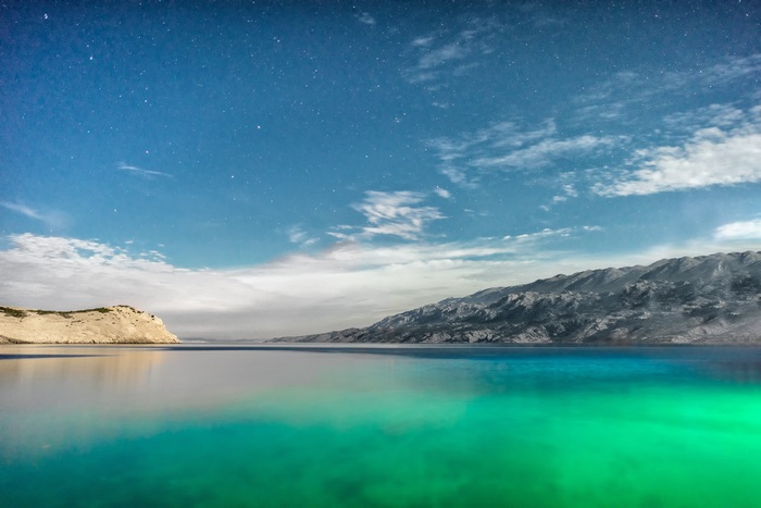 Mountains and sea under starry sky