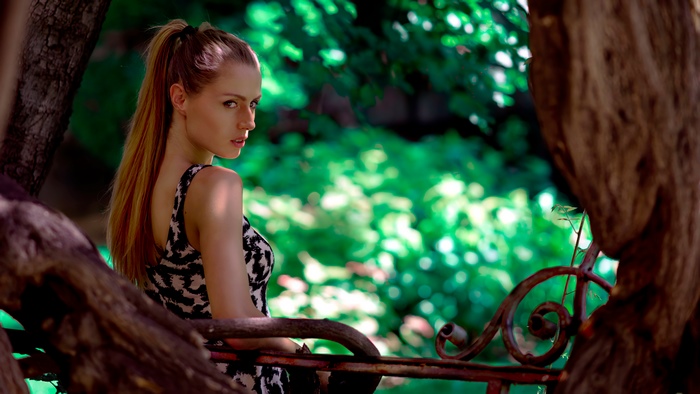 Woman with blonde ponytail in patterned dress