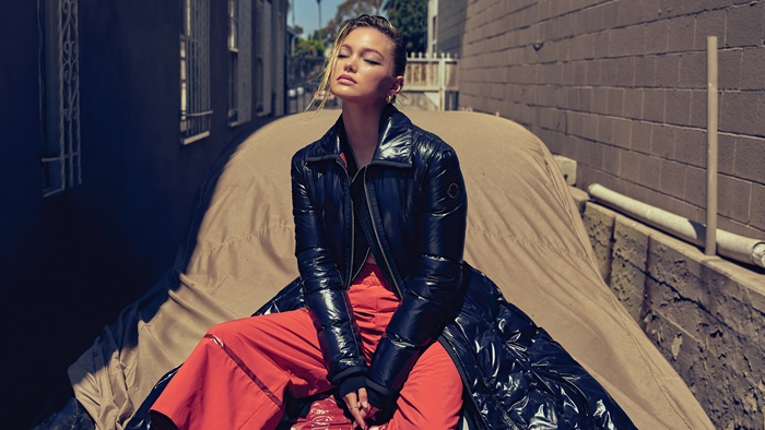 Olivia Holt in a Black Puffer Coat and Orange Pants