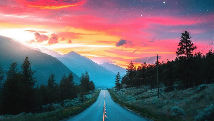 Road through mountains at sunset 4K