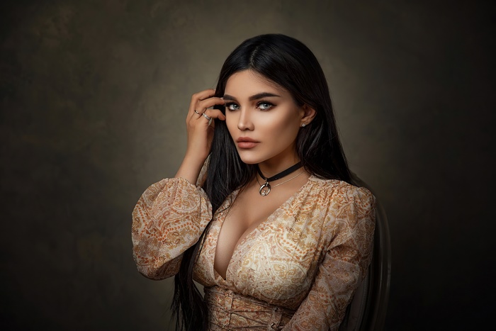 Elegant woman with dark hair in a patterned dress