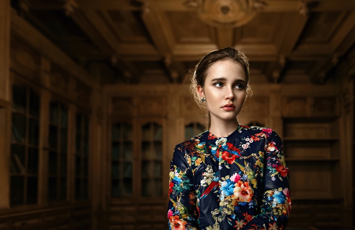 Model in floral jacket in ornate room