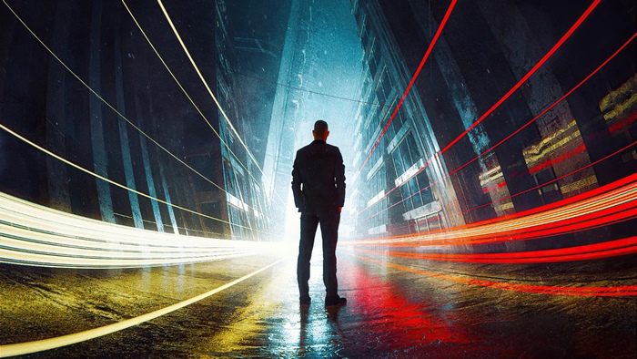 Man in suit standing in a futuristic city with light trails