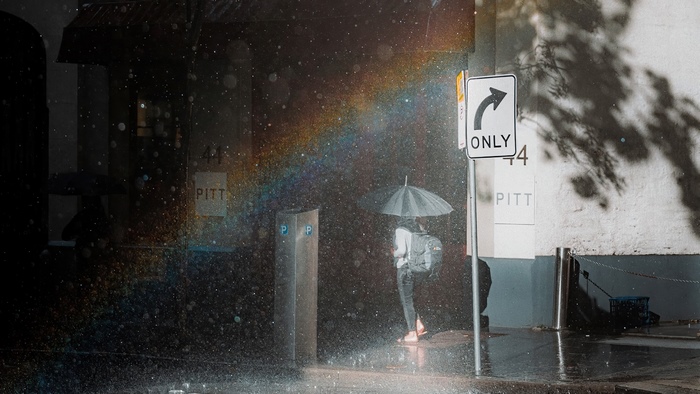 Person with umbrella in the rain on Pitt Street