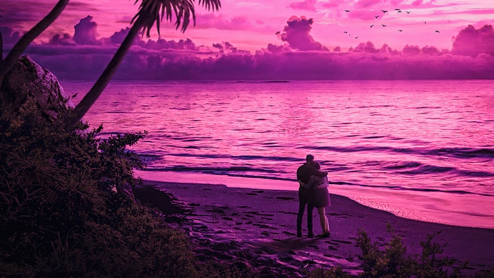 Couple embracing on a beach at sunset