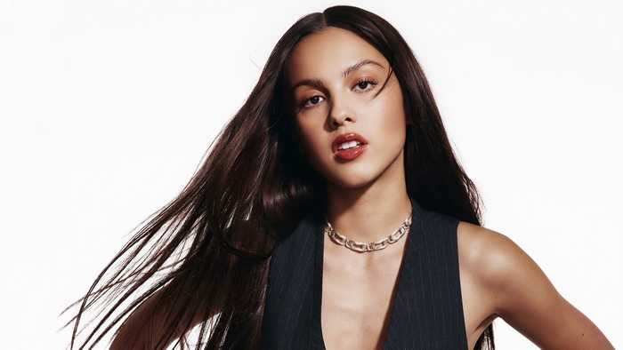 Olivia Rodrigo wearing a vest and necklace