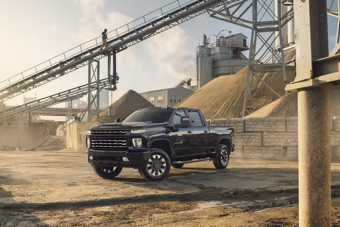 Black Chevrolet Silverado truck at industrial site