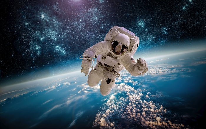 Astronaut floating above Earth with stars in background