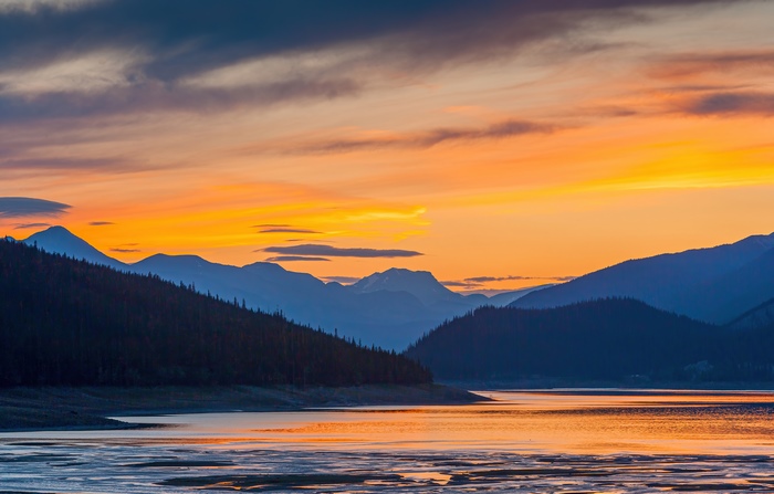 Sunset over mountains and lake