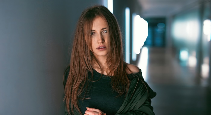 Brunette model in dark top and jacket