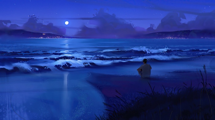 Person sitting on a beach at night