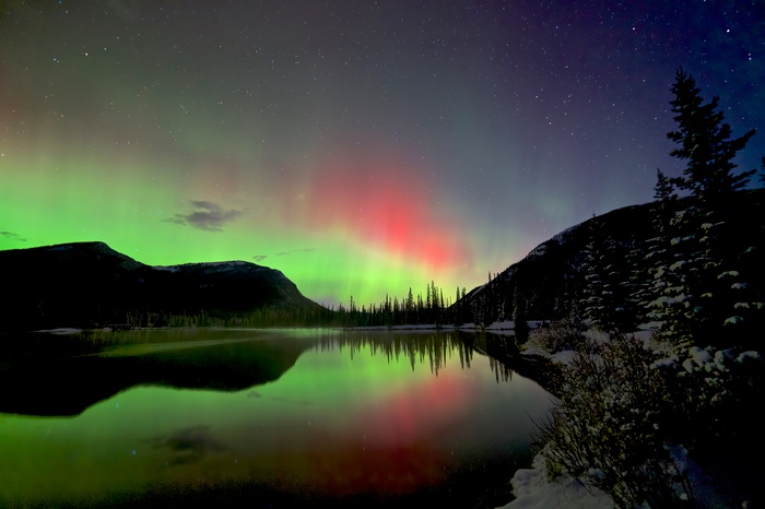 Aurora Borealis over a lake and mountains
