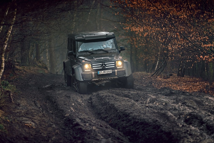 Mercedes G-Class driving on a muddy forest road
