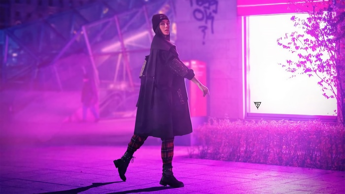 Woman in black coat and beanie in neon city