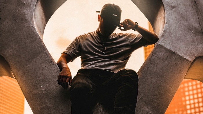 Man in cap and t-shirt sitting