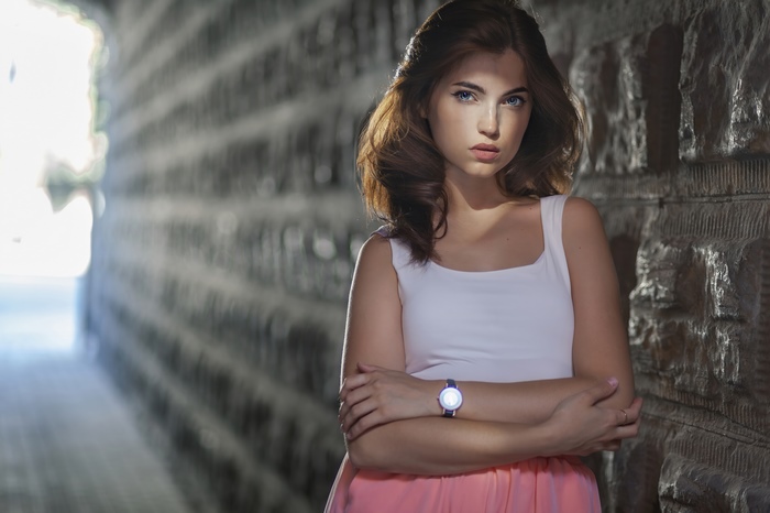 Young woman in white top and pink skirt