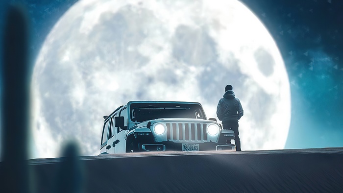 Man and Jeep under a large moon