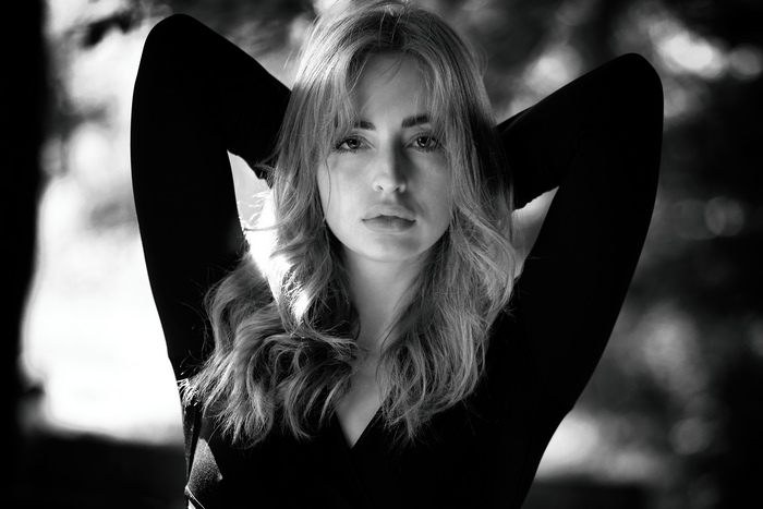 Monochrome portrait of a young woman in a black dress