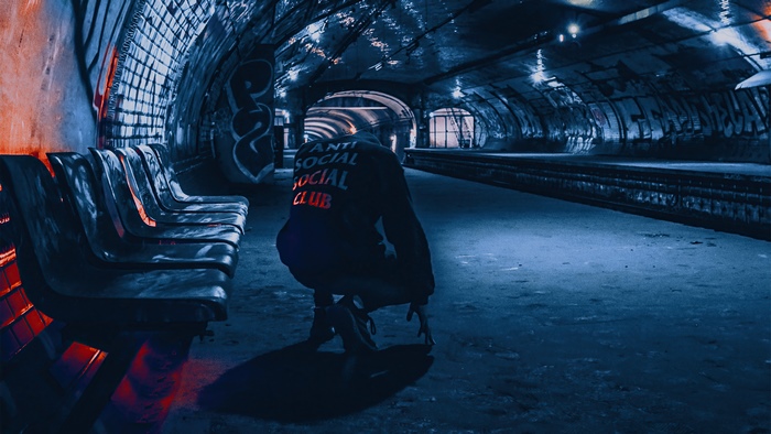 Person in hoodie in subway station