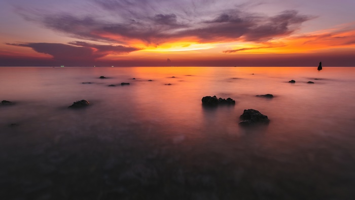 Ocean sunset with rocks and clouds 4K