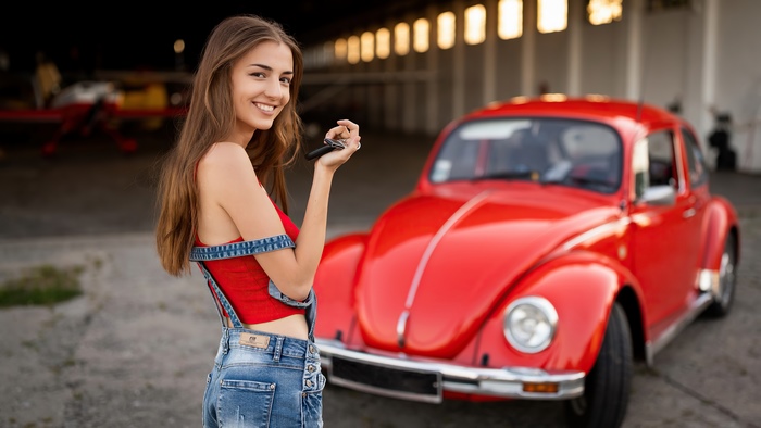 Girl with keys and red Volkswagen Beetle