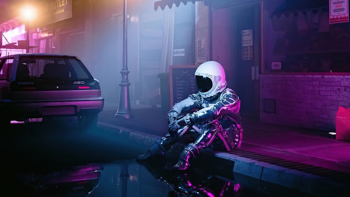 Astronaut sitting by a wet street with a Volvo car