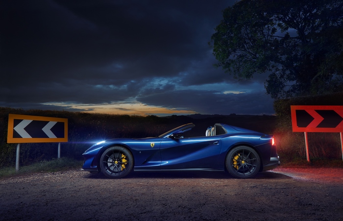 Blue Ferrari 812 GTS convertible on a dark road