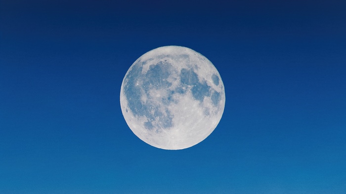 Full moon in a clear blue sky