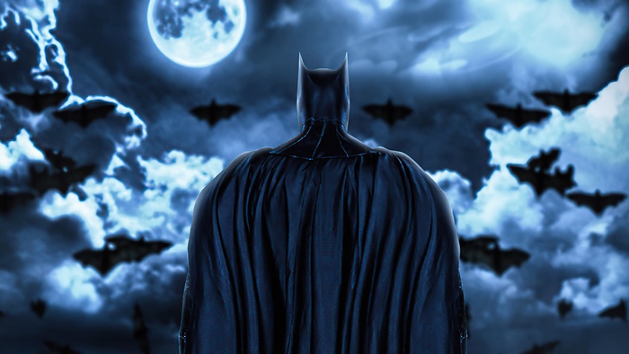 Batman in front of a full moon and bats