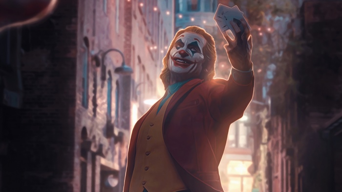 Joker holding cards in a city street