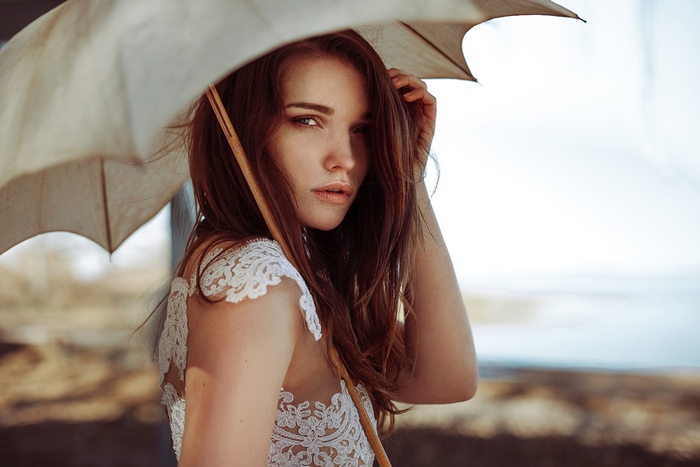 Woman with umbrella in white dress