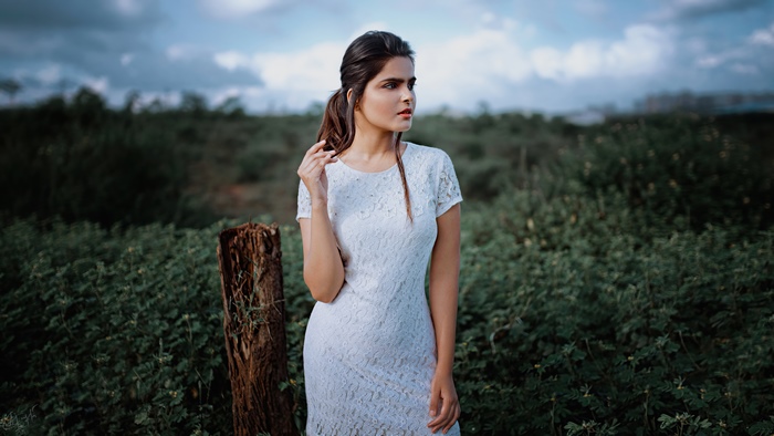 Woman in white dress in a field