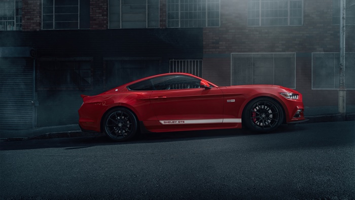 Red Ford Mustang Shelby GT500 parked on street