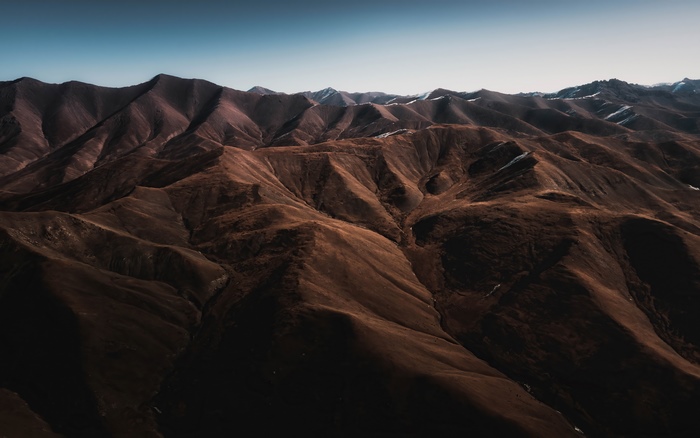 Brown mountains under a clear sky