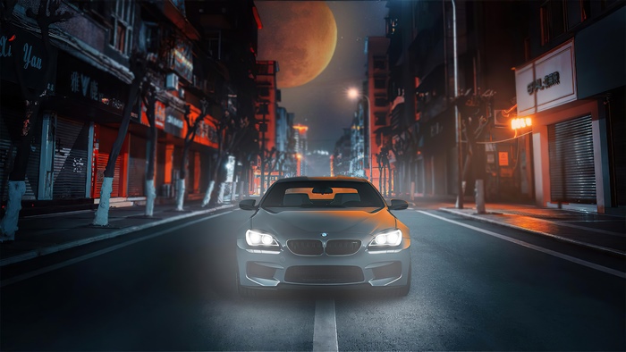 BMW M6 on a city street at night
