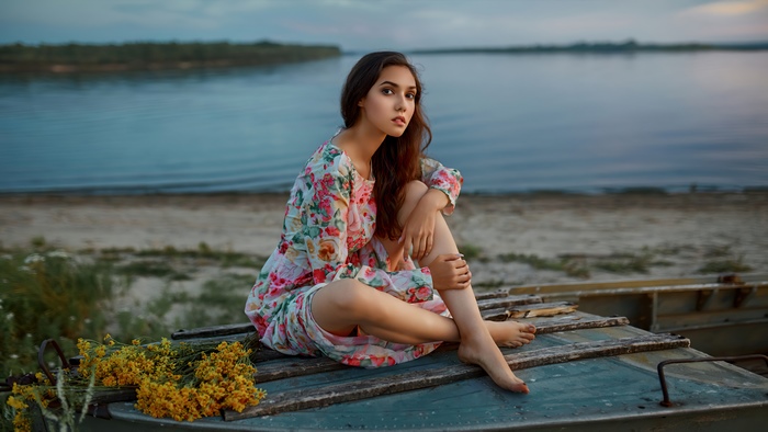Girl in floral dress by the lake
