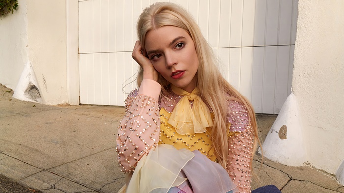 Anya Taylor-Joy sitting outdoors
