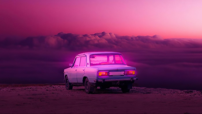 Vintage car on a cliff at sunset