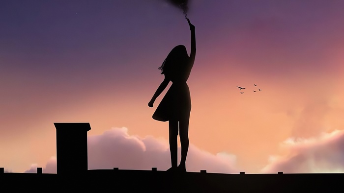 Silhouette of a girl holding a flare on a rooftop at sunset