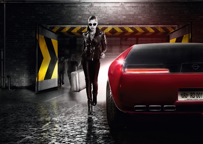 Woman with suitcase and red Opel car