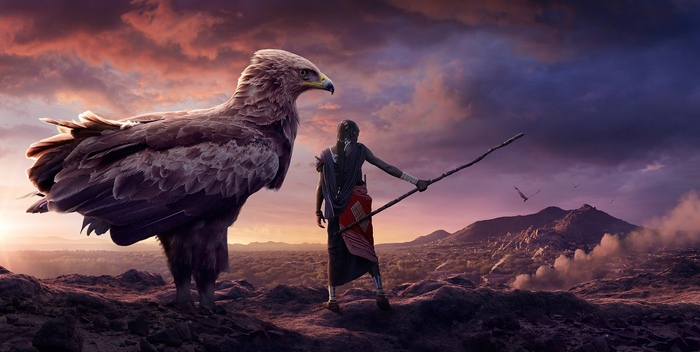 Eagle and warrior on a mountain at sunset